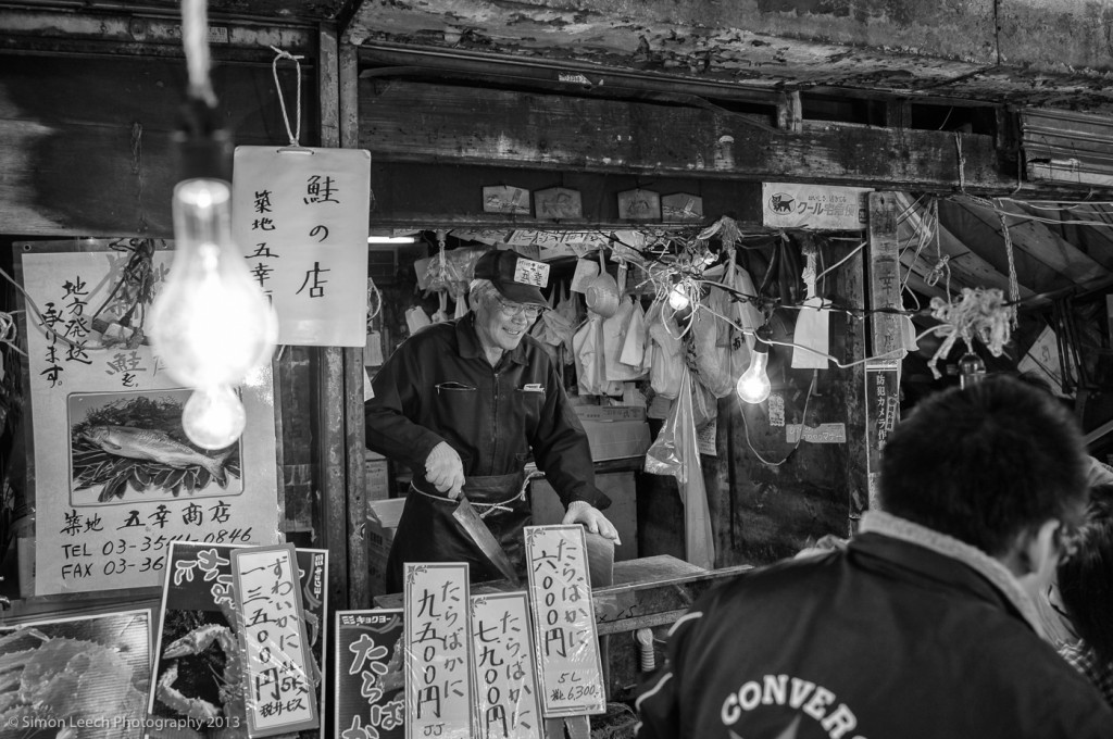 Tsukiji Market Trader preparing freshly caught fish for sale